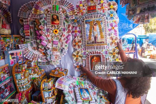 Vendor sells merchandising during the traditional "Alasitas" fair, in the city of Puno in the southern highlands of Peru, on May 3, 2022. - Peruvians...