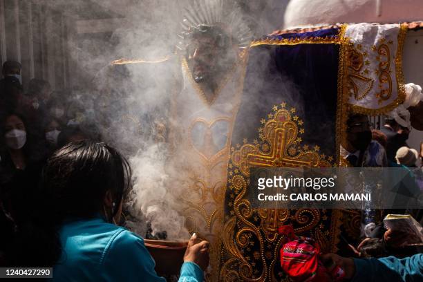 Woman attends the traditional "Alasitas" fair, in the city of Puno in the southern highlands of Peru, on May 3, 2022. - Peruvians and Bolivians...