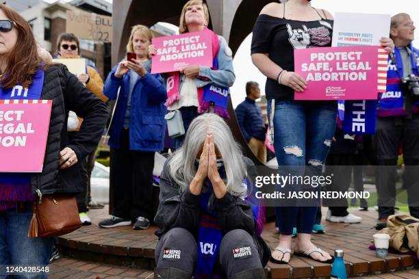 Jackie Jacobs, of Seattle and member of the Lumbee Tribe in North Carolina, bows her head as people gather at Kerry Park in response to an intent to...