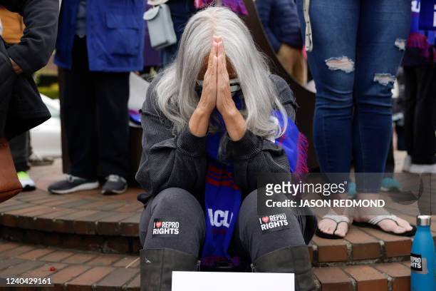Jackie Jacobs, of Seattle and member of the Lumbee Tribe in North Carolina, bows her head as people gather at Kerry Park in response to an intent to...