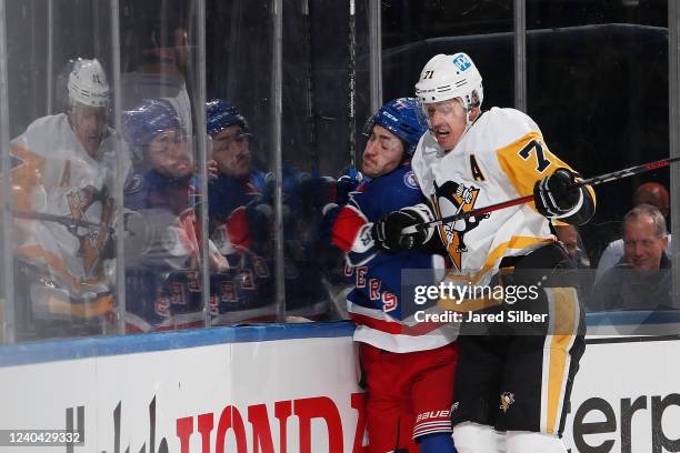 Evgeni Malkin of the Pittsburgh Penguins checks Frank Vatrano of the New York Rangers into the boards in Game One of the First Round of the 2022...