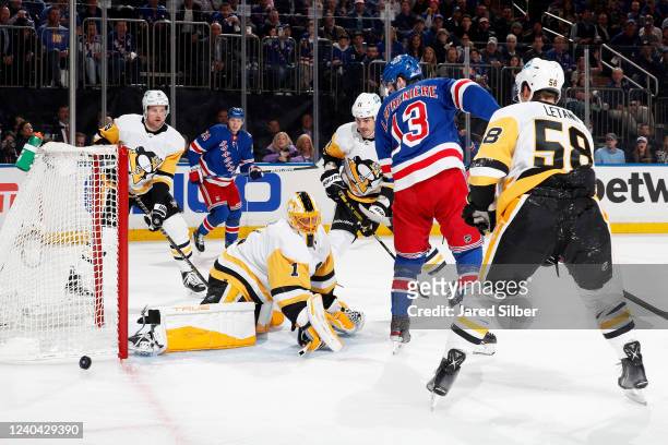 Casey DeSmith of the Pittsburgh Penguins makes a save as Alexis Lafrenière of the New York Rangers looks for the rebound in Game One of the First...