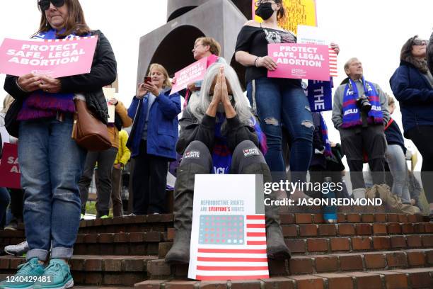 Jackie Jacobs, of Seattle and member of the Lumbee Tribe in North Carolina, bows her head as people gather at Kerry Park in response to an intent to...