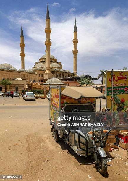 Fruit seller's electric tuk-tuk is parked outside al-Noor Islamic Complex in the Sudanese capital's northern district of Khartoum-Bahri, on April 19,...