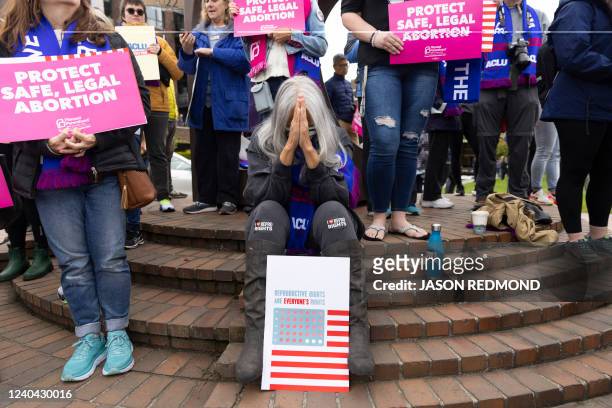 Jackie Jacobs, of Seattle and member of the Lumbee Tribe in North Carolina, bows her head as people gather at Kerry Park during a pro-choice rally...