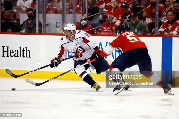 Alex Ovechkin of the Washington Capitals skates for possession against Aaron Ekblad of the Florida Panthers in Game One of the First Round of the...