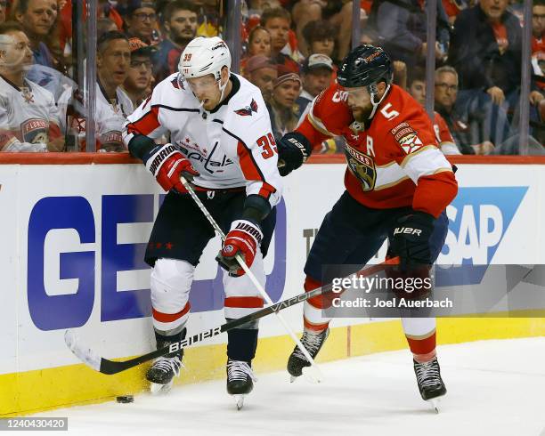 Aaron Ekblad of the Florida Panthers and Anthony Mantha of the Washington Capitals battle for control of the puck during second period action in Game...