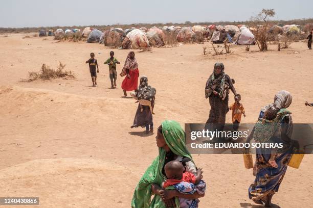 Women and children stand in the camp for internally displaced people of Farburo 2 in the village of Adlale, near the city of Gode, Ethiopia, on April...