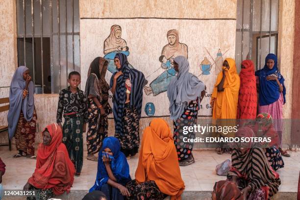 Internally displaced people wait during a food distribution organised by the World Food Program in the village of Adlale, near the city of Gode,...