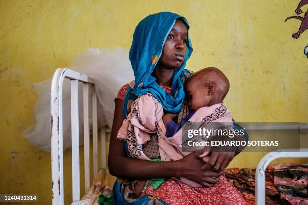 Woman holds a malnourished child at the nutrition unit of the Kelafo Health Center in the town of Kelafo, 120 kilometers from the city of Gode,...