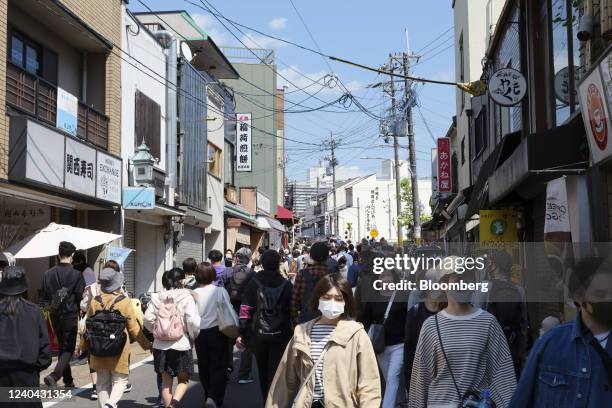 Pedestrians walk along a street near Fushimi Inari shrine during Golden Week holidays in Kyoto, Japan, on Tuesday, May 2022. Japans hospitality...