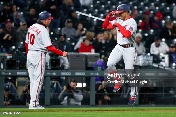 Juan Soto of the Washington Nationals celebrates with Gary Disarcina after hitting a home run against the Colorado Rockies during the fifth inning at...