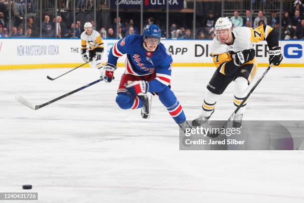 Nathan Beaulieu of the Pittsburgh Penguins pursues the puck against Jeff Carter of the Pittsburgh Penguins in Game One of the First Round of the 2022...