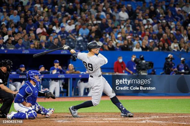 Aaron Judge of the New York Yankees hits an RBI double, batting in Aaron Hicks, in the seventh inning of their MLB game against the Toronto Blue Jays...
