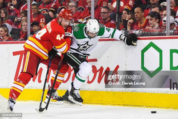 Erik Gudbranson of the Calgary Flames battles Alexander Radulov of the Dallas Stars for the puck during the second period of Game One of the First...