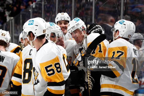 Evgeni Malkin of the Pittsburgh Penguins celebrates with teammates after scoring the game winning goal in Triple OT against the New York Rangers in...