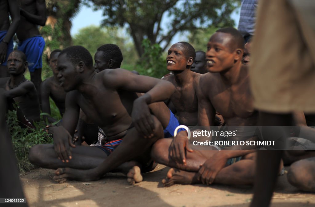 South Sudanese men look at members of th