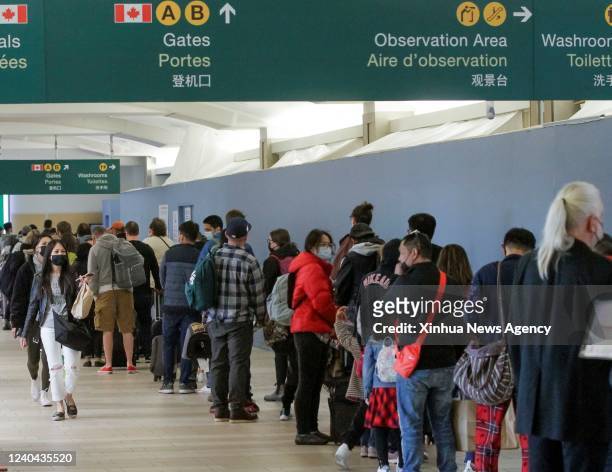 People line up for security screening at Vancouver International Airport in Richmond, British Columbia, Canada, on May 3, 2022. Travelers have...