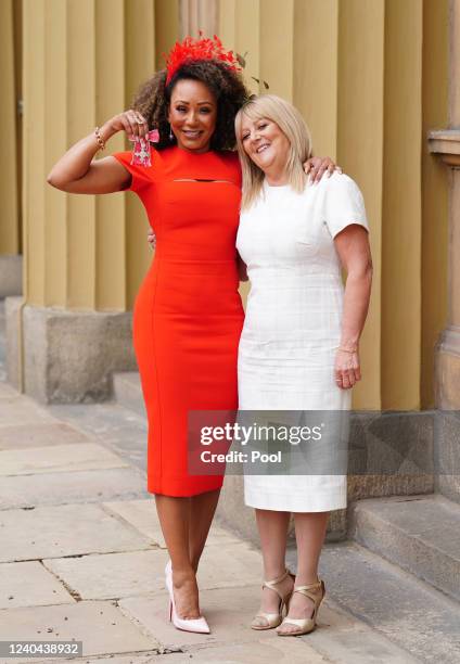 Former Spice Girl Melanie Brown poses with her mother Andrea Brown after she was made an MBE by the Duke of Cambridge during an investiture ceremony...