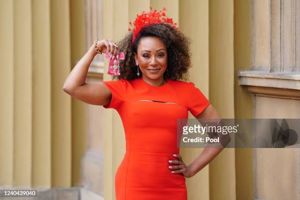 Former Spice Girl Melanie Brown poses after she was made an MBE by the Duke of Cambridge during an investiture ceremony at Buckingham Palace on May...
