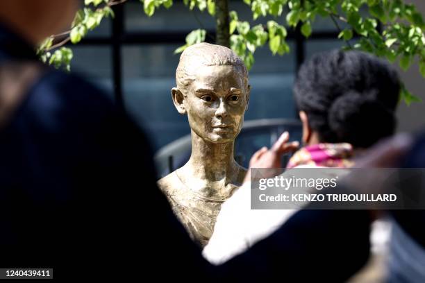 People takes pictures of a statue of British actress Audrey Hepburn made by Dutch artist Kees Verkade and offered by the actress' son to the city of...