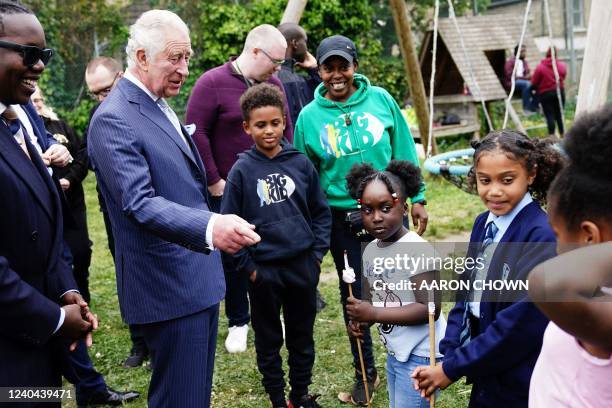 Britain's Prince Charles, Prince of Wales speaks with children, during a visit at the Dexters Adventure Playground in Brixton, south London, on May...