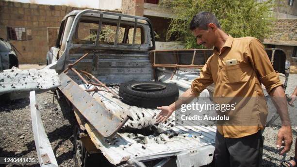 Damaged vehicles and a man are seen after an attack carried out with unmanned aerial vehicle by the Iranian-backed Houthis in Taizi Yemen on May 04,...