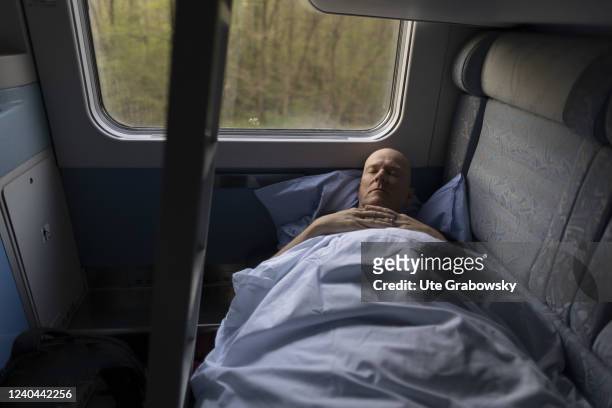 In this photo illustration a man is sleeping in a night train on his way to Zagreb.