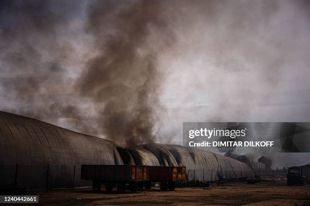 Smoke billows from a burning storage building after having been shelled in the village of Temyrivka on May 4 amid the Russian invasion of Ukraine. -...