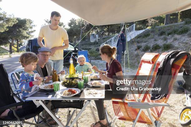 In this photo illustration a family is having a meal on a campsite.