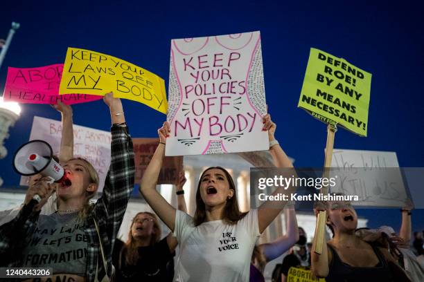 Pro-choice demonstrators, including Emma Harris, left, and Ellie Small, center, both students at George Washington University gather in front of the...