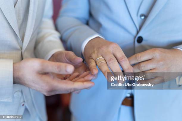 In this photo illustration a man i putting on a wedding ring.