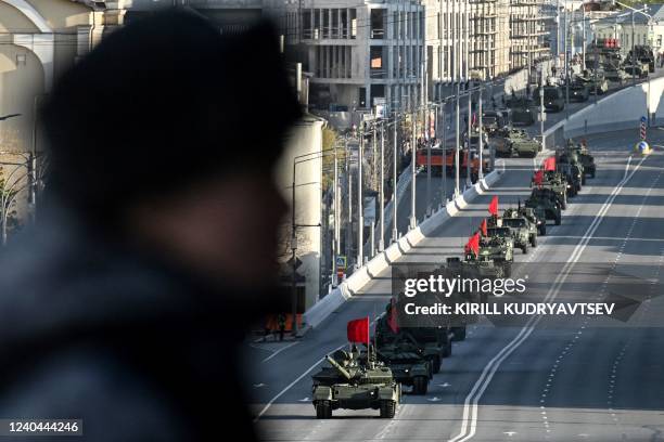 Russian T-90M tank and other military vehicles drive along the Garden Ring road towards the Red Square for a rehearsal of the Victory Day military...