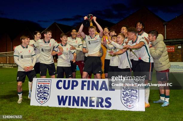 Captain Tom Clayton of Liverpool lifts the trophy after the Lancashire Senior Cup final at Lancashire FA County Ground on May 4, 2022 in Leyland,...
