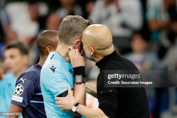 Referee Daniele Orsato talks to coach Pep Guardiola of Manchester City during the UEFA Champions League match between Real Madrid v Manchester City...