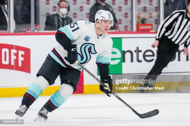 Derrick Pouliot of the Seattle Kraken skates in the neutral zone during the second period of a game against the Winnipeg Jets at Canada Life Centre...