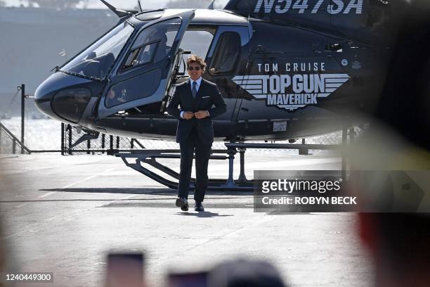 Actor Tom Cruise arrives in a helicopter to the world premiere of "Top Gun: Maverick!" aboard the USS Midway in San Diego, California on May 4, 2022.