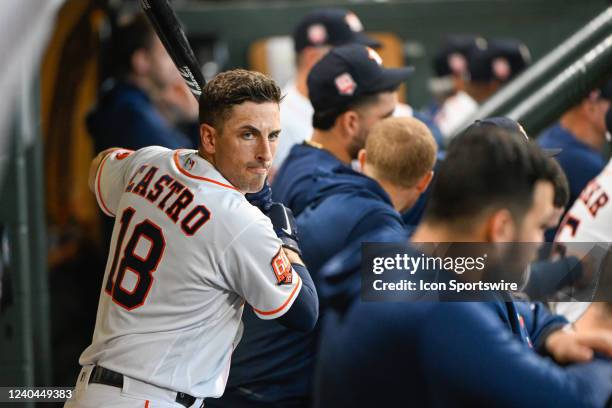 Houston Astros catcher Jason Castro warms up in the dugout during the baseball game between the Seattle Mariners and Houston Astros at Minute Maid...