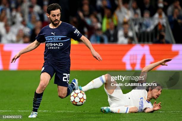 Manchester City's Portuguese midfielder Bernardo Silva vies with Real Madrid's Croatian midfielder Luka Modric during the UEFA Champions League...