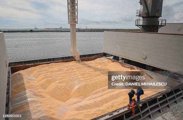 Workers assist the loading of corn on to a ship at Pier 80 in the Black Sea port of Constanta, Romania on May 3, 2022. - The Romanian port seeks to...