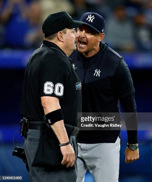 Manager Aaron Boone of the New York Yankees argues with home plate umpire Marty Foster in the eighth inning during a MLB game against the Toronto...