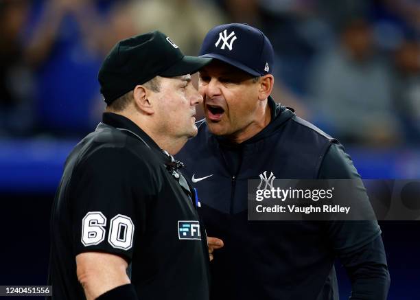 Manager Aaron Boone of the New York Yankees argues with home plate umpire Marty Foster in the eighth inning during a MLB game against the Toronto...