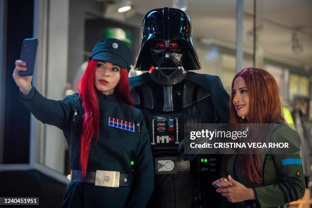 Fans dressed as their favorite characters of the film Star Wars, make a selfie on the Star Wars Day, at the Plaza de las Americas, in Quito, on May...