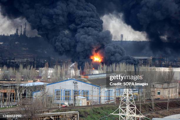 Large black puffs of smoke from a fire are visible due to Russian missiles hitting an oil storage facility. Russia invaded Ukraine on 24 February...