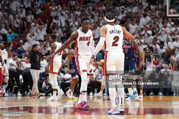 Victor Oladipo of the Miami Heat and Gabe Vincent of the Miami Heat high-five during Game 2 of the 2022 NBA Playoffs Eastern Conference Semifinals on...