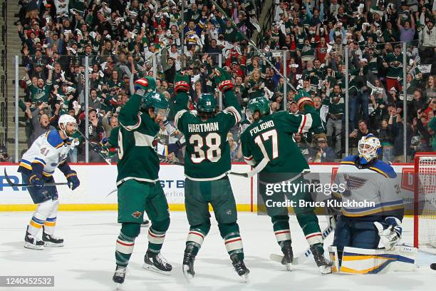 Frederick Gaudreau celebrates his goal with his teammates Ryan Hartman and Marcus Foligno of the Minnesota Wild while Robert Bortuzzo and Ville Husso...