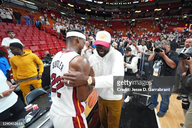 Jimmy Butler of the Miami Heat and Dwyane Wade high-five after Game 2 of the 2022 NBA Playoffs Eastern Conference Semifinals on May 4, 2022 at The...
