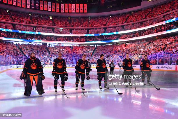 Mike Smith, Darnell Nurse, Connor McDavid, Cody Ceci, Jesse Puljujarvi and Evander Kane of the Edmonton Oilers stand for the singing of the national...