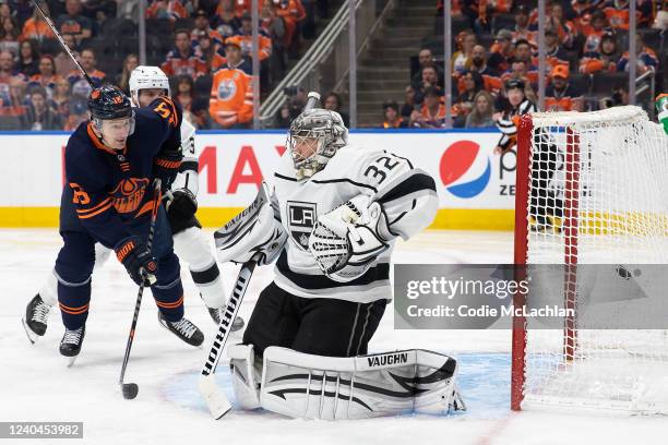 Zach Hyman of the Edmonton Oilers looks on as the puck goes past goaltender Jonathan Quick of the Los Angeles Kings during the second period in Game...