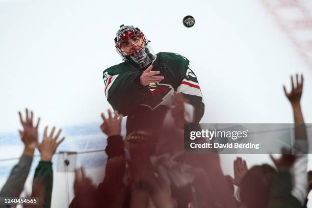 Marc-Andre Fleury of the Minnesota Wild throws a puck to fans as he's announced as the third star of the game against the St. Louis Blues in Game Two...